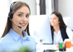 Two ladies with headphones working for Managed IT Services - VOIP Phone System Sales And Support